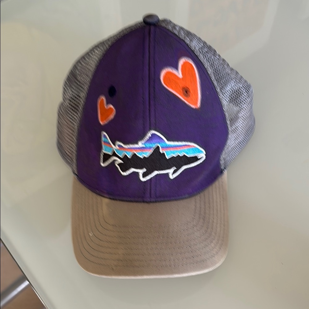 Purple and gray Fitz Roy Trout Trucker Hat embellished with paint and hearts